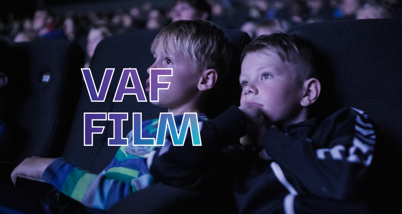 Two boys sitting in a cinema watching a movie. There's a VAF FILM sign above the screen.